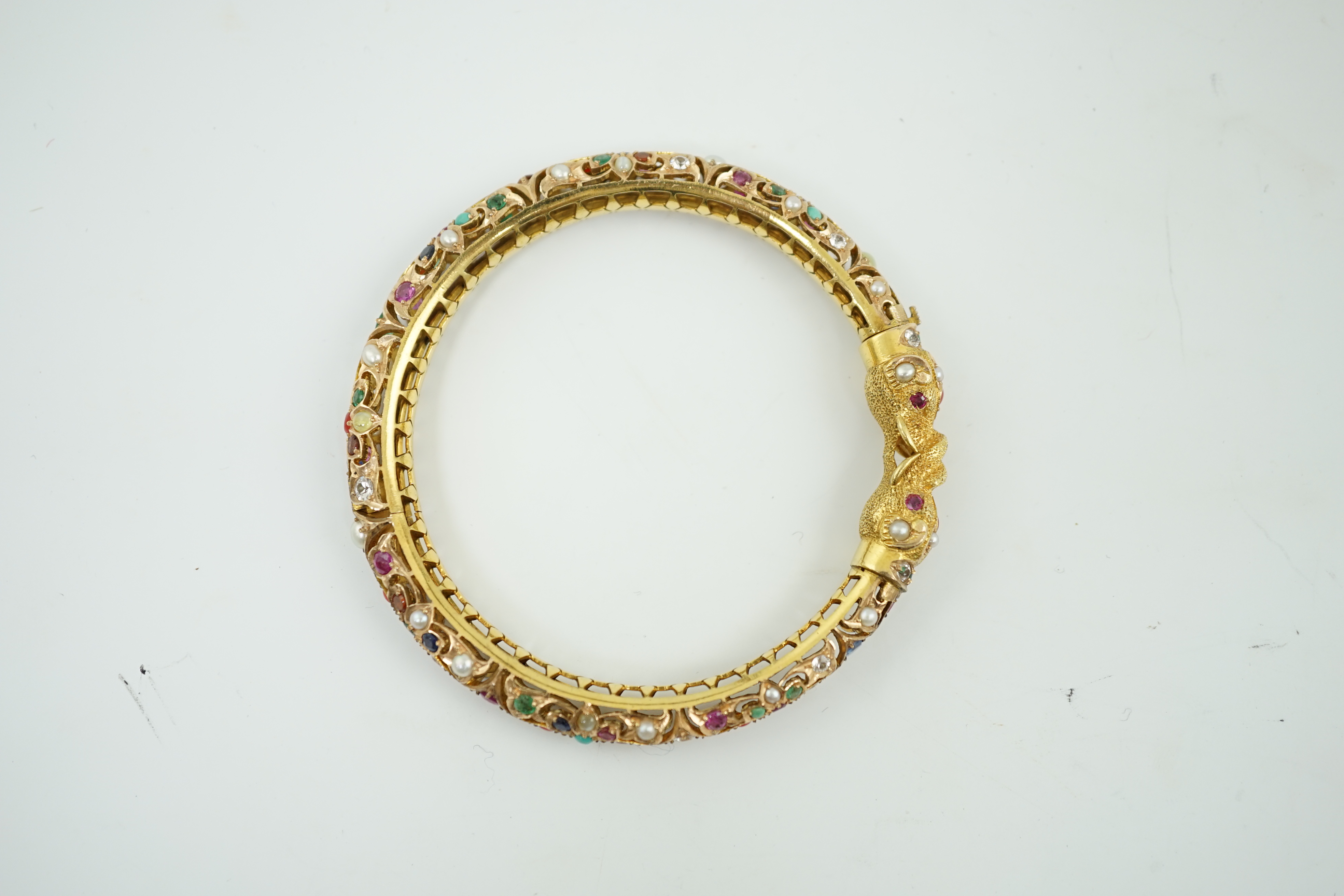 An Indian gold and multi gem set hinged bangle